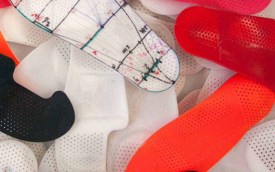 SOLS prototype orthotics in red, white, and black — material testing phase